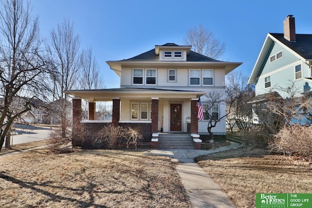 traditional style home with a porch and brick siding