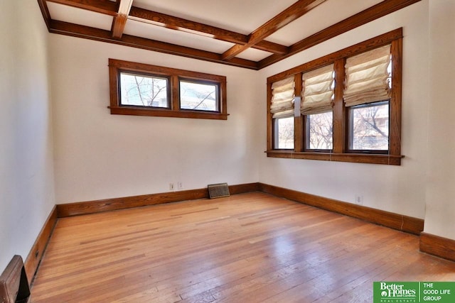 unfurnished room featuring light wood-style flooring, visible vents, baseboards, and coffered ceiling