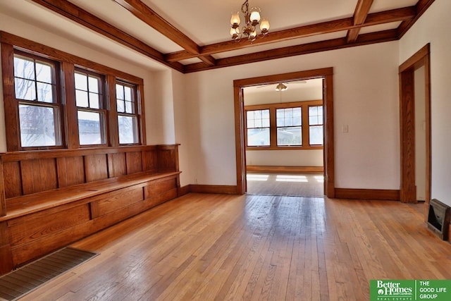 interior space with light wood finished floors, coffered ceiling, and baseboards