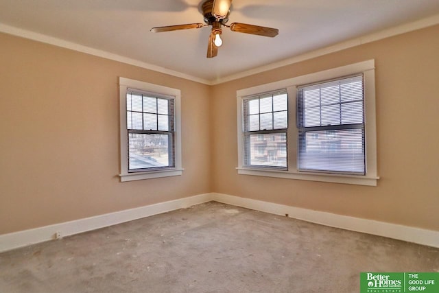 spare room with crown molding, plenty of natural light, and baseboards