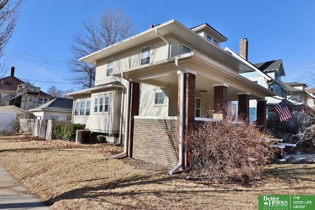 view of home's exterior with brick siding, central AC, and fence