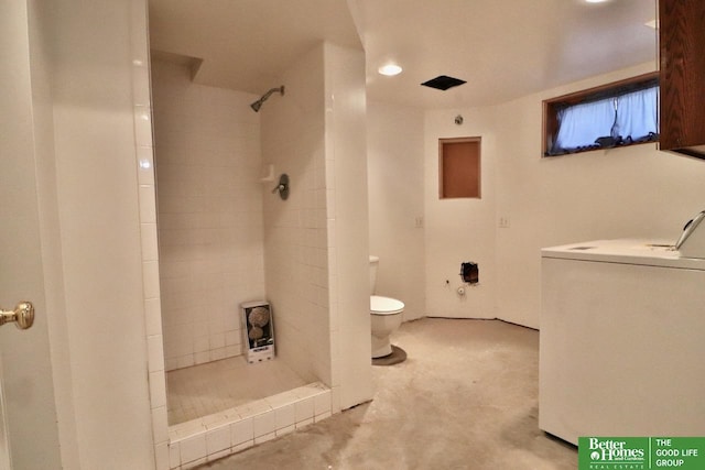 full bathroom with toilet, a shower stall, washer / clothes dryer, and concrete floors