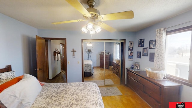 bedroom with ceiling fan, a closet, and light wood-type flooring