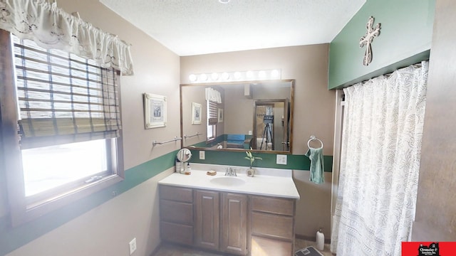 bathroom featuring a textured ceiling and vanity