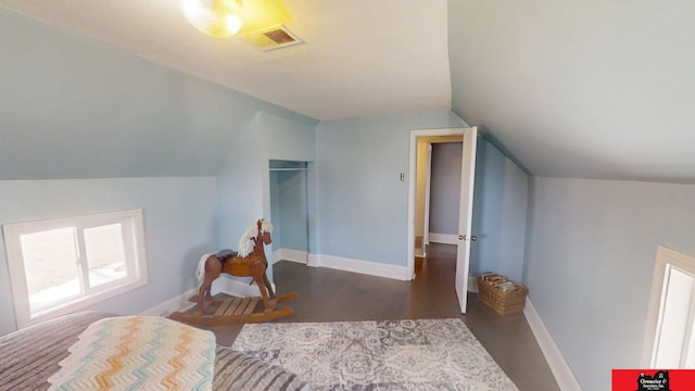 bonus room with vaulted ceiling, wood finished floors, visible vents, and baseboards