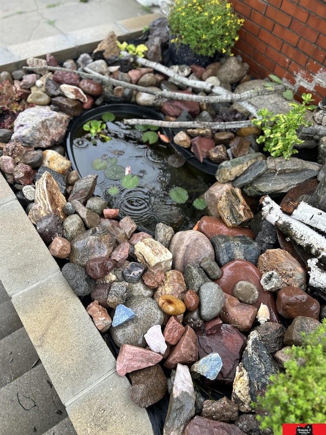 exterior details with a small pond