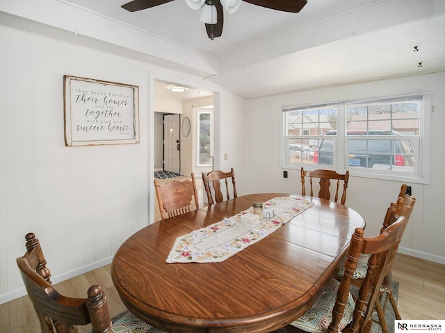 dining area with ceiling fan, baseboards, and light wood-style flooring