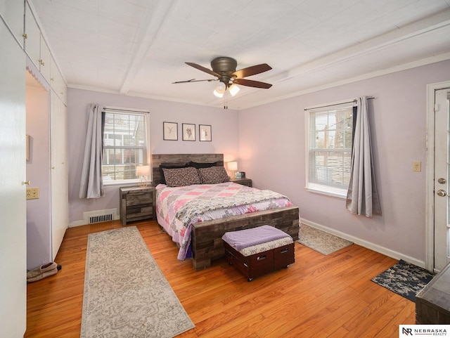 bedroom featuring visible vents, baseboards, light wood-style floors, and a ceiling fan