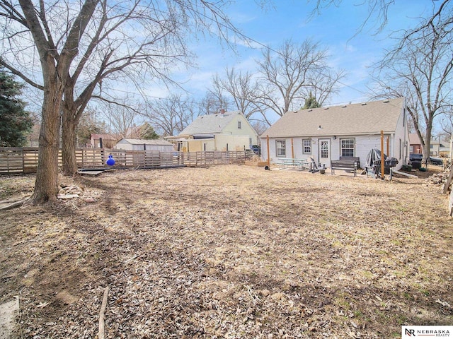 view of yard featuring entry steps and fence private yard