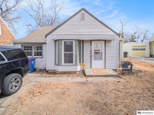 view of front of home with a shingled roof