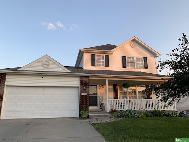 traditional home with brick siding, covered porch, an attached garage, and driveway