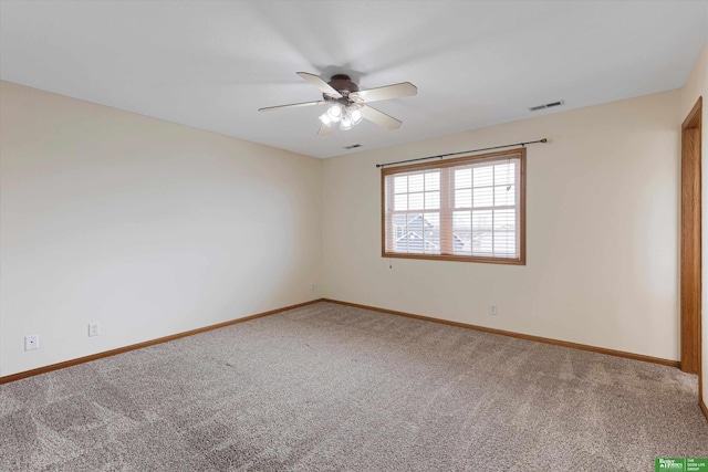 unfurnished room with visible vents, a ceiling fan, baseboards, and carpet floors