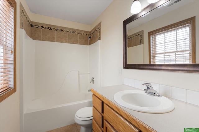 full bathroom with vanity, visible vents, bathing tub / shower combination, toilet, and tile patterned floors