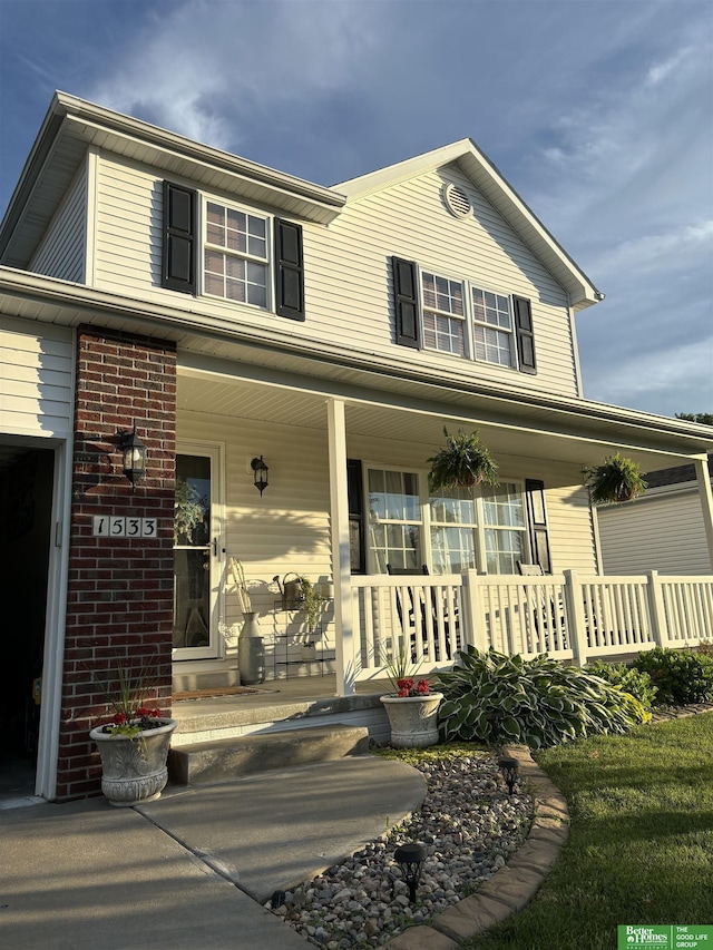 view of front of property with brick siding and covered porch