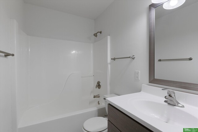 bathroom with shower / bath combination, toilet, and vanity