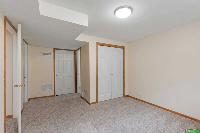 unfurnished bedroom with visible vents and light carpet