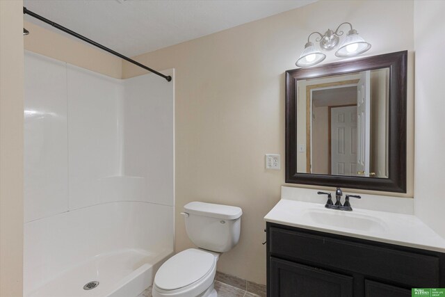 full bathroom featuring toilet, vanity, and walk in shower