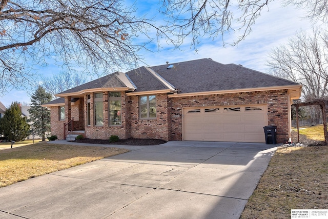 ranch-style house featuring brick siding, driveway, a garage, and roof with shingles