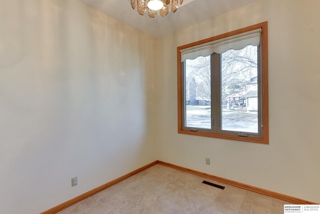 spare room with a healthy amount of sunlight, visible vents, and baseboards