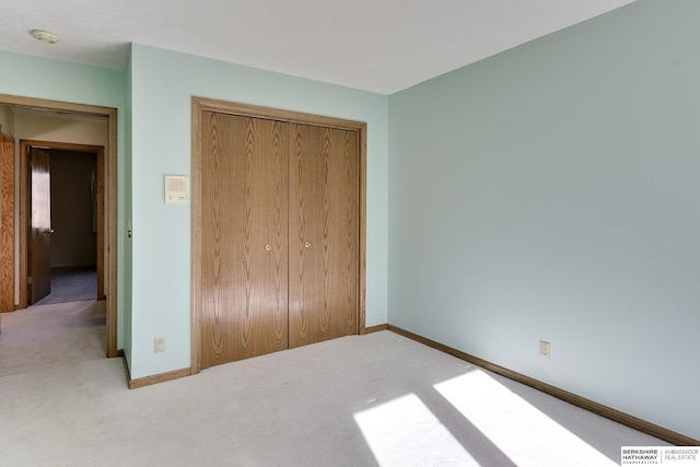 unfurnished bedroom featuring a closet, baseboards, visible vents, and carpet flooring