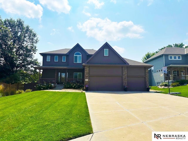 view of front of property featuring an attached garage, a porch, concrete driveway, and a front yard