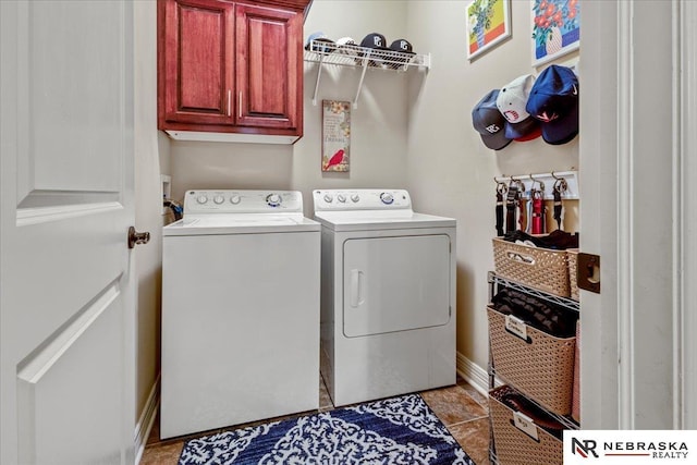 clothes washing area featuring cabinet space, light tile patterned floors, and washer and dryer