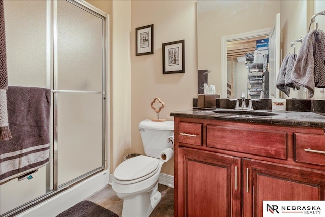 full bathroom featuring toilet, a stall shower, and vanity