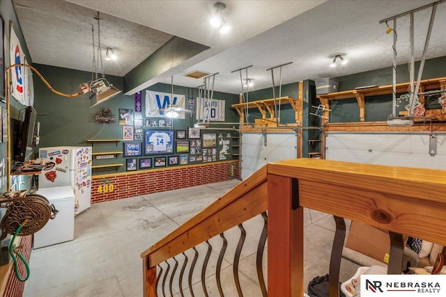 kitchen featuring unfinished concrete floors and a textured ceiling