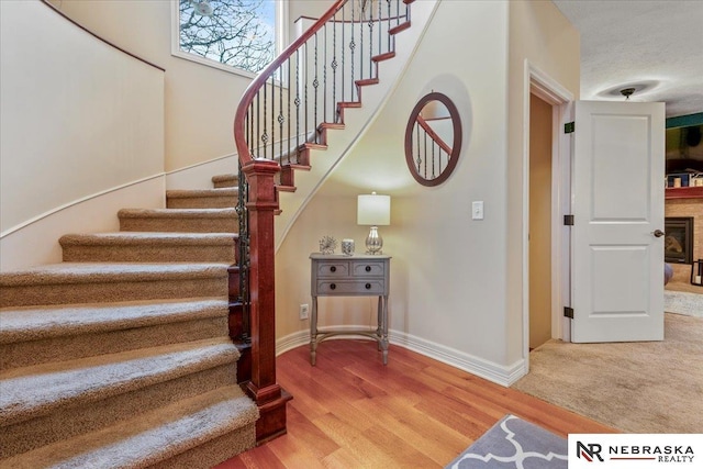 stairway featuring wood finished floors and baseboards