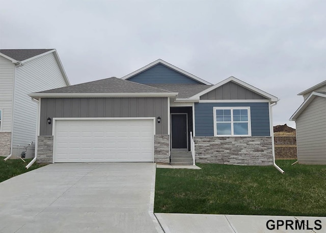 view of front of property with board and batten siding, a shingled roof, concrete driveway, a front yard, and a garage