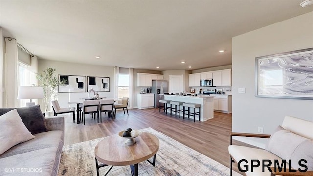 living room with recessed lighting and light wood-style flooring