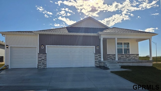 view of front of home with covered porch, concrete driveway, and a garage