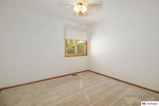 empty room with visible vents, baseboards, ceiling fan, and carpet flooring