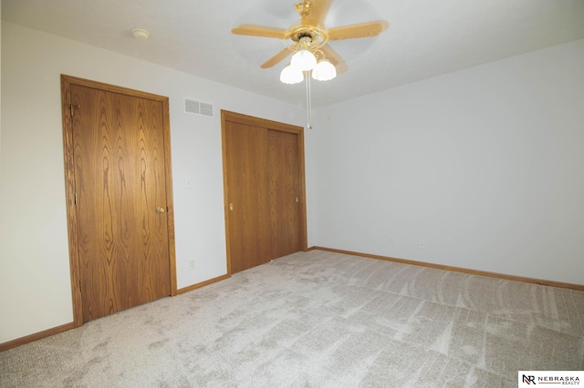 unfurnished bedroom with visible vents, baseboards, and carpet floors