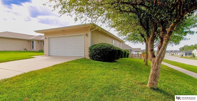 ranch-style home with an attached garage, concrete driveway, a front yard, and fence