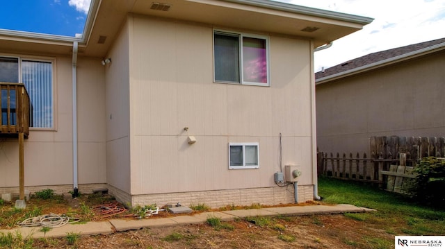 view of property exterior featuring fence