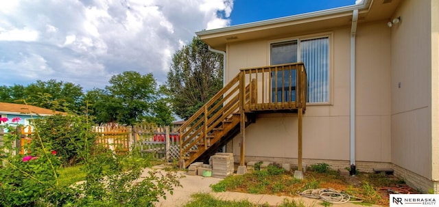 exterior space featuring stairway and fence