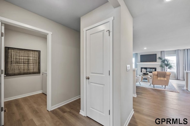 hallway with baseboards and wood finished floors