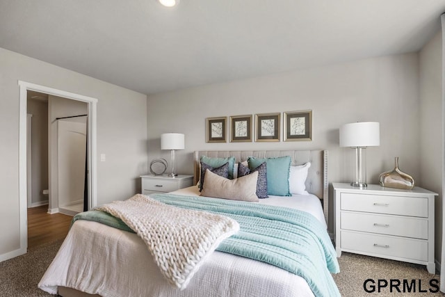 bedroom with baseboards and carpet