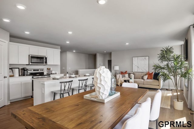 dining space with recessed lighting and wood finished floors