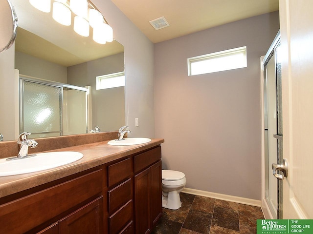 bathroom with a sink, visible vents, baseboards, and a stall shower