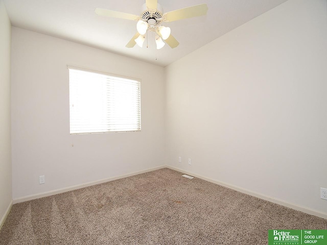 spare room featuring a ceiling fan, visible vents, baseboards, and carpet floors