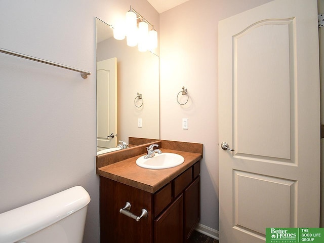 bathroom with toilet and vanity