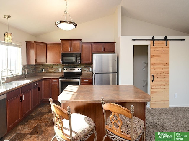 kitchen featuring lofted ceiling, tasteful backsplash, appliances with stainless steel finishes, and a sink