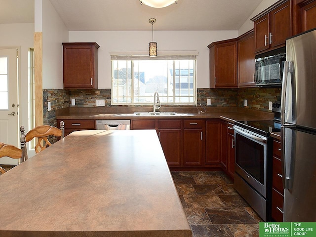 kitchen with backsplash, a center island, stone finish flooring, stainless steel appliances, and a sink