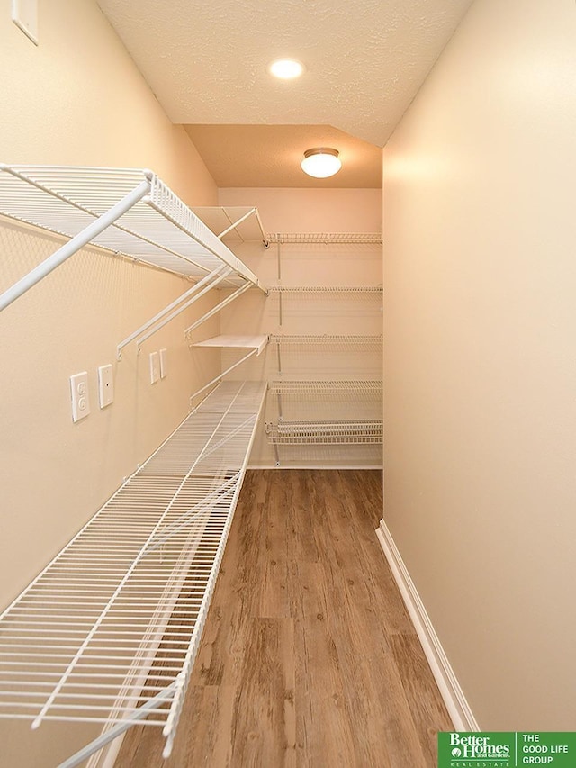 spacious closet with wood finished floors