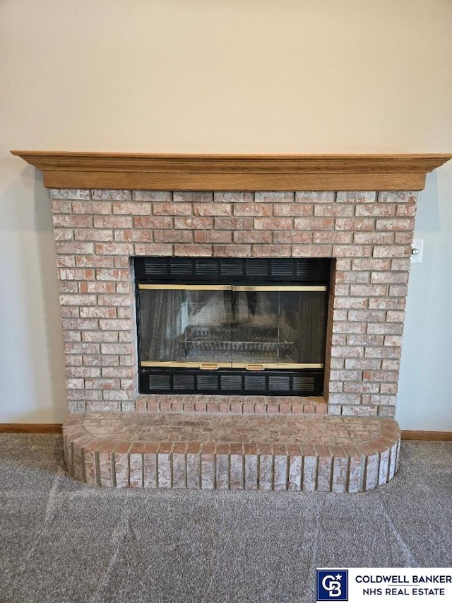 interior details featuring baseboards, carpet floors, and a fireplace