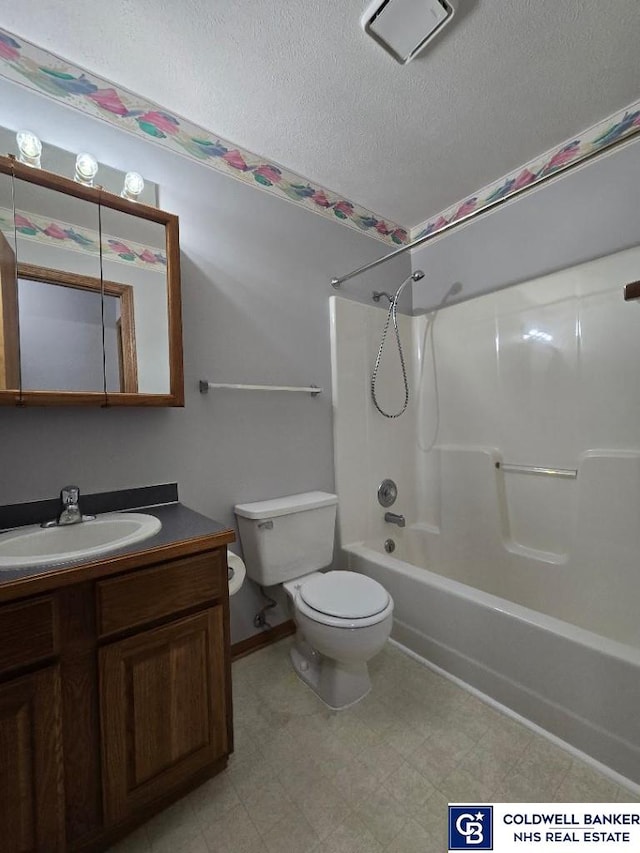 full bathroom with tile patterned floors, toilet, a textured ceiling, vanity, and shower / bathtub combination