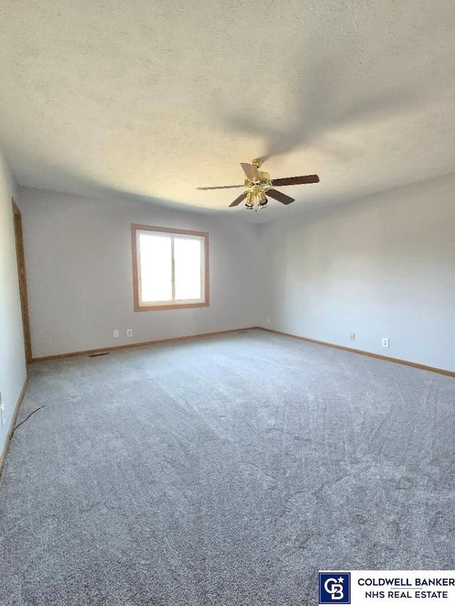 unfurnished room with light colored carpet, a textured ceiling, and ceiling fan