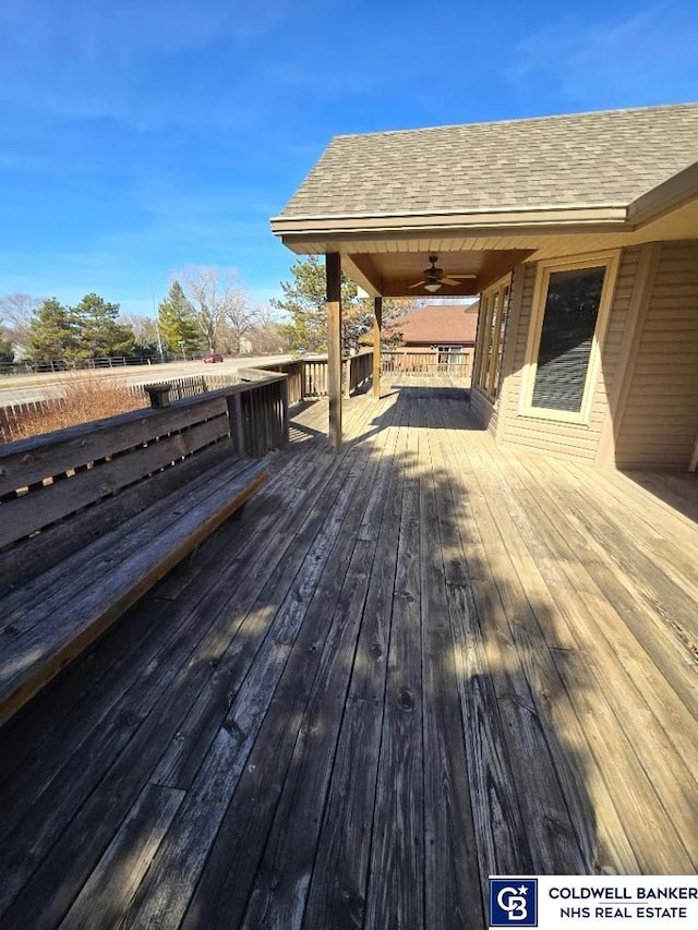 wooden terrace with a ceiling fan